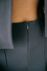 a close up of a person wearing a gray shirt