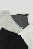 A group of three shorts sitting next to each other