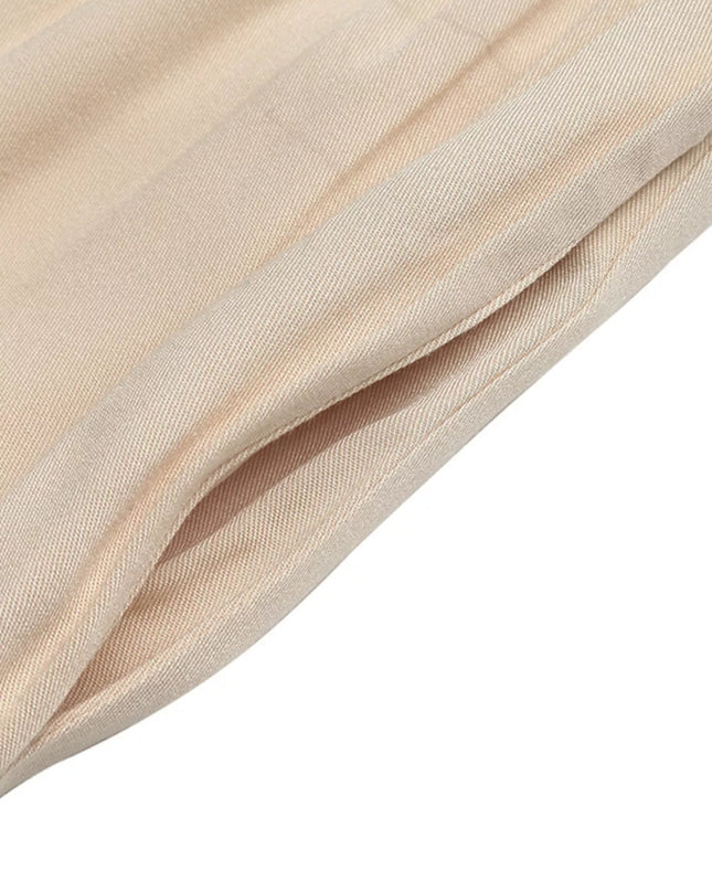 Tan wide leg jumpsuit with pocket detail and textured fabric