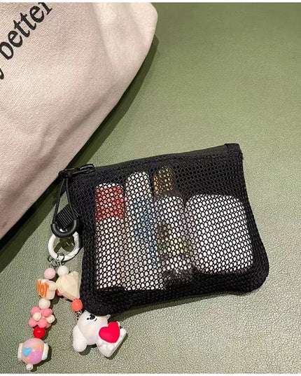 Black mesh makeup bag with lipsticks, keychain charms, coin purse, and card holder - portable travel essential.